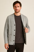 Men's Button Up Cardigan in grey, textured cotton-feel knit, worn open to show the tartan-check lining
