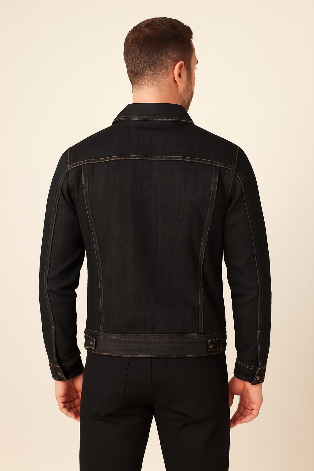 Back view of the men's denim jacket in black on a model