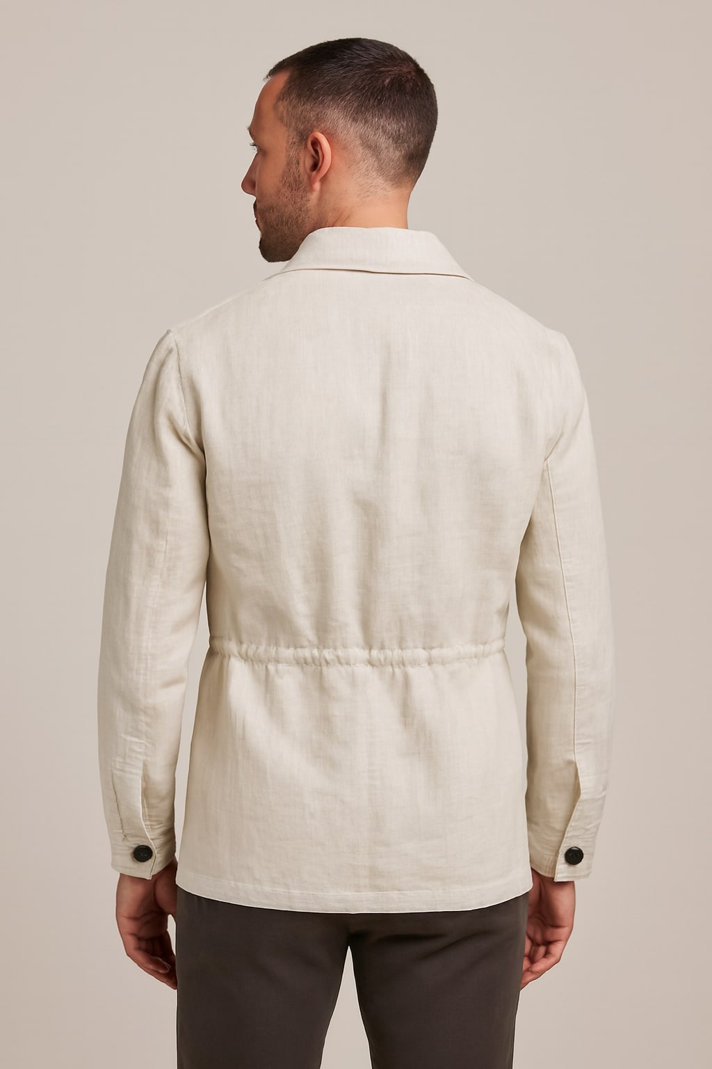 Back view of the men's field coat in white on a model
