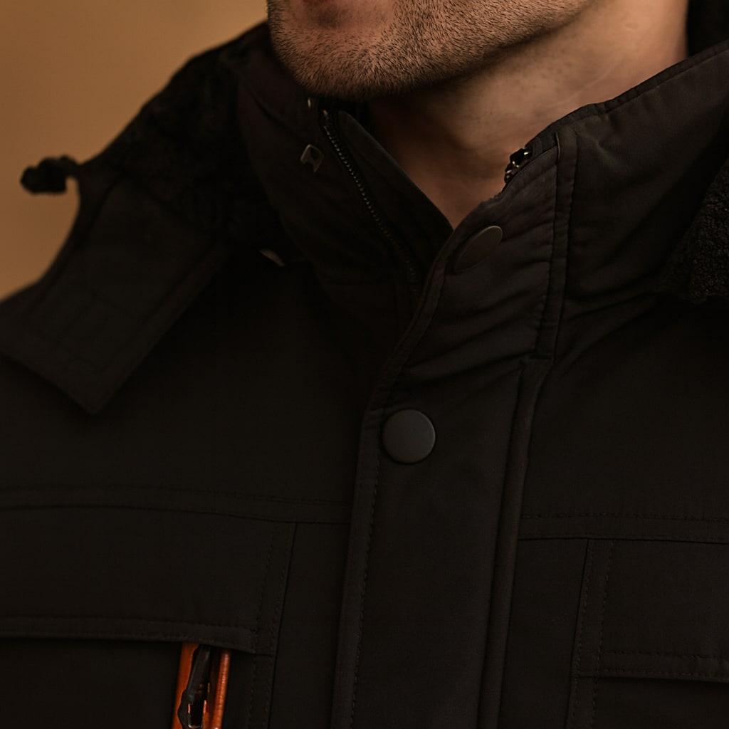 Close-up of the men's hooded parka jacket showing the detachable hood and zip pull