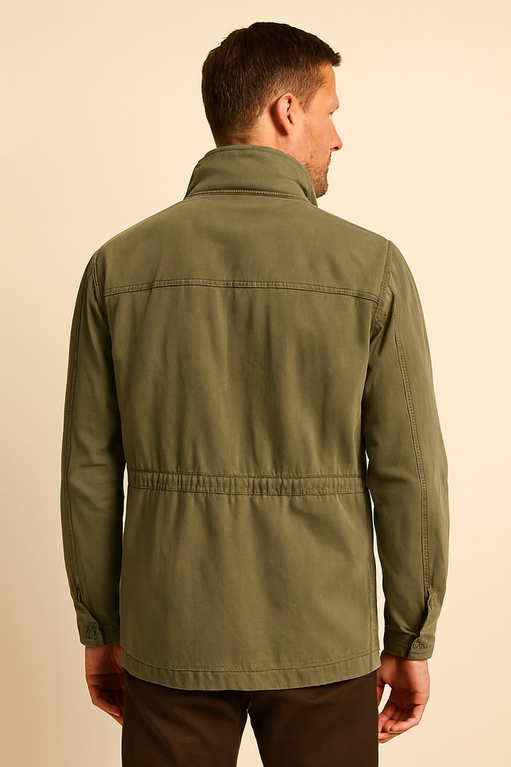 Back view of the men's olive utility jacket in olive green on a model