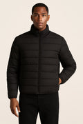 Men's Puffer Jacket in black, quilted zip-up winter coat, front view on a model