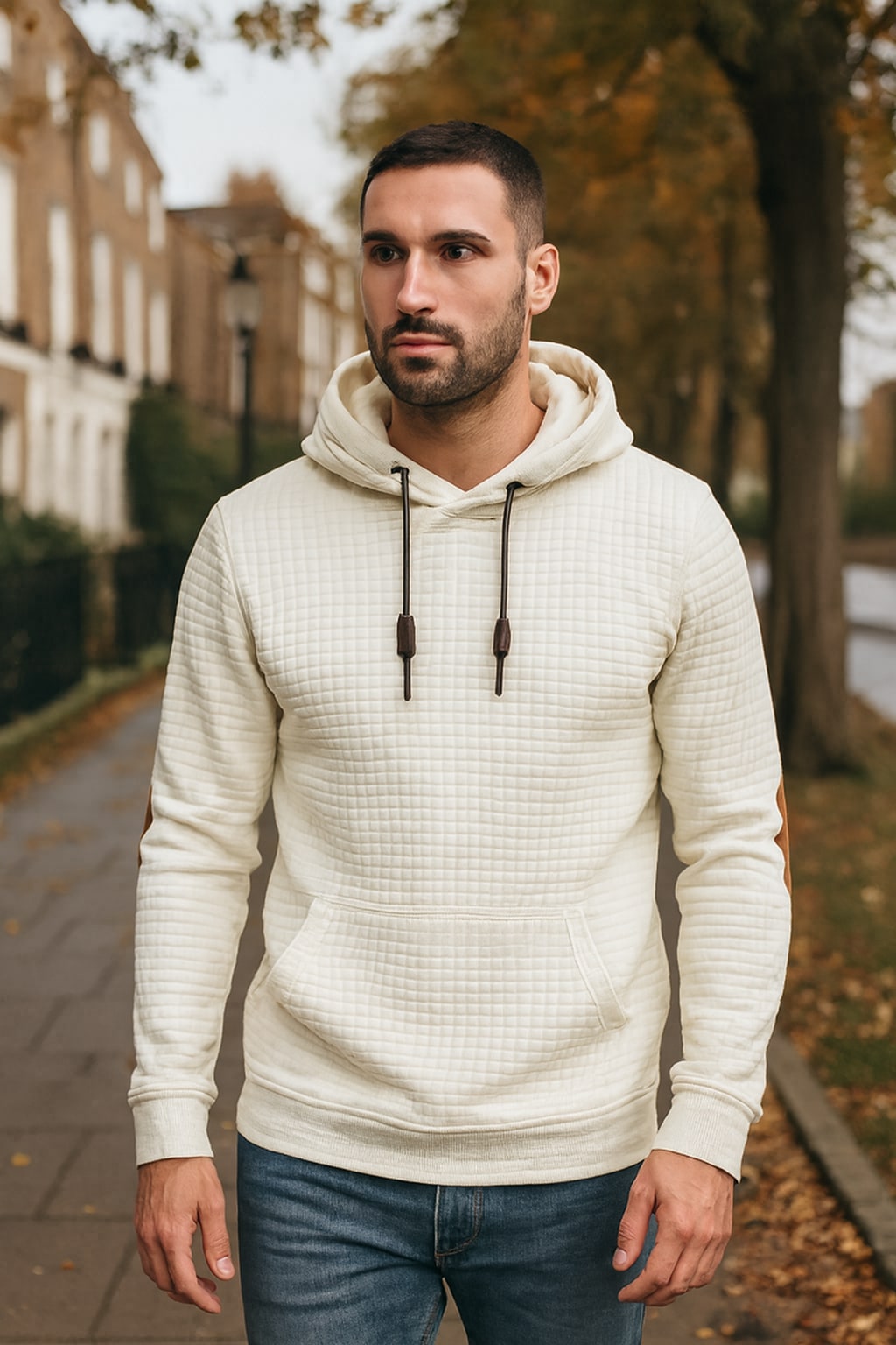 Man wearing the men's pullover hoodie on an autumn street