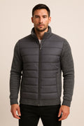 Men's Quilted Puffer Jacket in dark grey, fleece sleeve hybrid, front view on a model